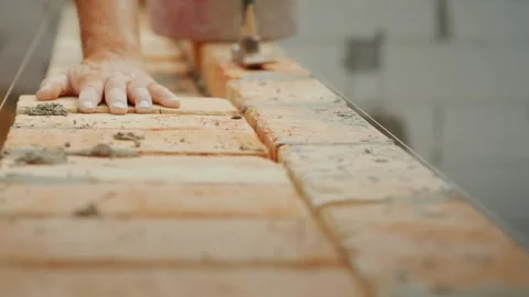 Installation of walls with red brick Stock Footage 324564933