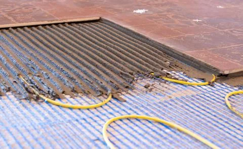 Installation of a warm floor from a cable. electric heating system with ceramic Stock Photos