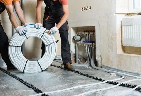 Installation of a warm floor. Stock Photos