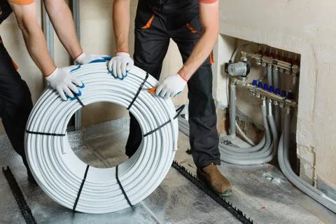Installation of a warm floor. Stock Photos