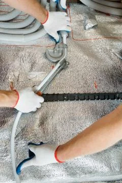 Installation of a warm floor. Stock Photos