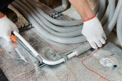 Installation of a warm floor. Stock Photos