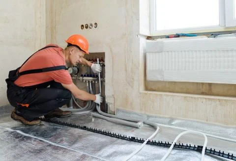 Installation of a warm floor. Stock Photos