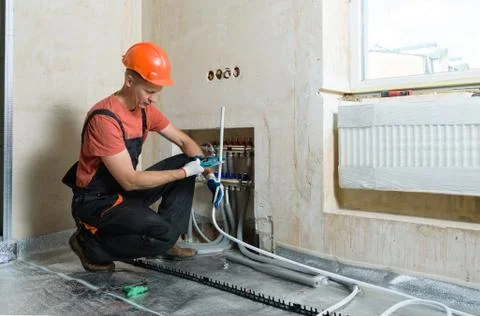Installation of a warm floor. Stock Photos
