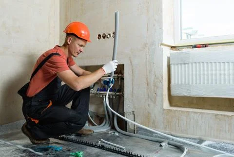 Installation of a warm floor. Stock Photos