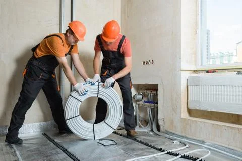Installation of a warm floor. Stock Photos