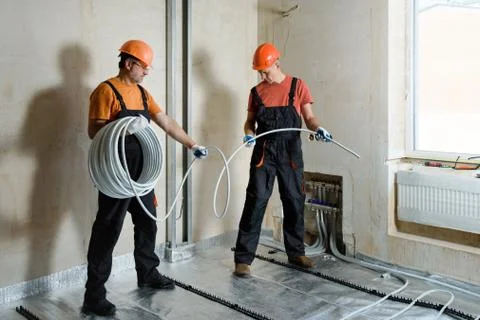 Installation of a warm floor. Stock Photos
