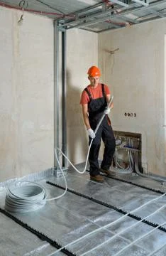 Installation of a warm floor. Stock Photos