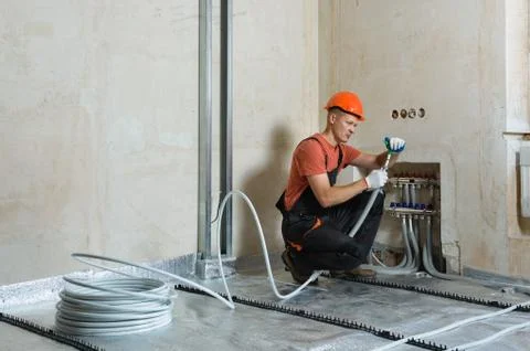 Installation of a warm floor. Stock Photos