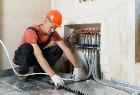 Installation of a warm floor. Stock Photos