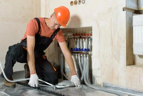 Installation of a warm floor. Stock Photos
