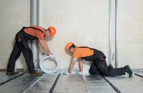 Installation of a warm floor. Stock Photos
