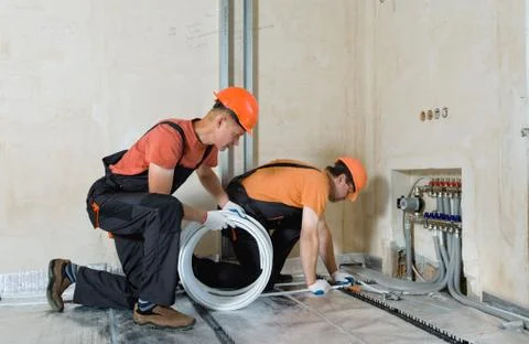 Installation of a warm floor. Stock Photos