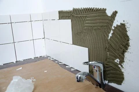 Installation of white kitchen tiles Stock Photos