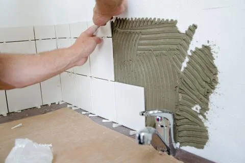 Installation of white kitchen tiles Stock Photos