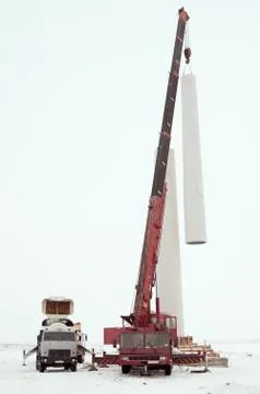 Installation of a wind turbine tower using a crane Stock Photos