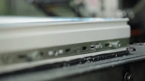 Installation of window hardware in the factory line. Automated equipment sets wi Stock Footage 199486769