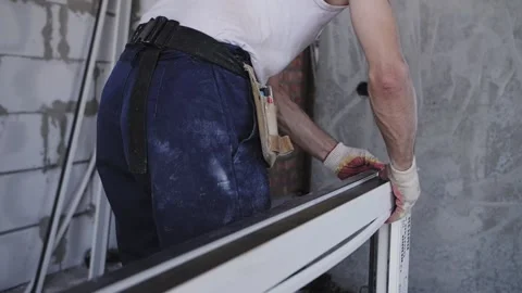 Installation of a window in a house under construction Stock Footage 219424084