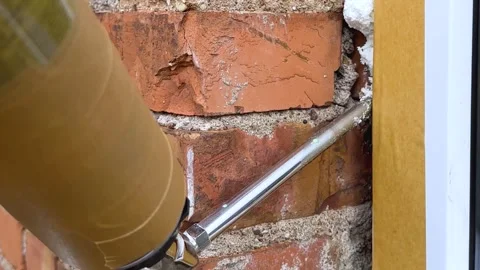 Installation of a window. The process of insulating windows with construction Stock Footage 276566907