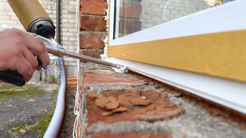 Installation of a window. The process of insulating windows with construction Stock Footage 276566942