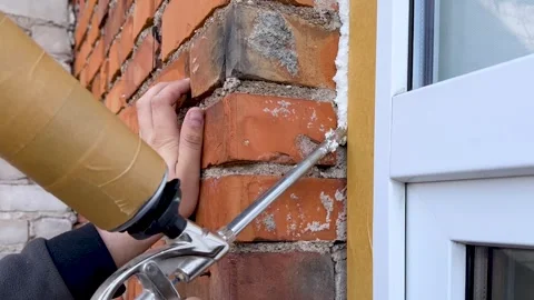 Installation of a window. The process of insulating windows with construction Stock Footage 276566977