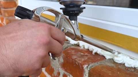 Installation of a window. The process of insulating windows with construction Stock Footage 277160467