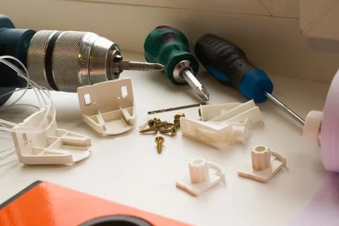 Installation of a window roller with a holder. Installation tool. Screwdrivers,  Stock Photos