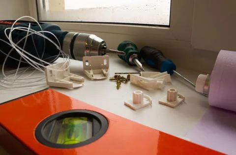 Installation of a window roller with a holder. Installation tool. Screwdrivers,  Stock Photos