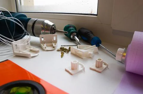 Installation of a window roller with a holder. Installation tool. Screwdrivers,  Stock Photos