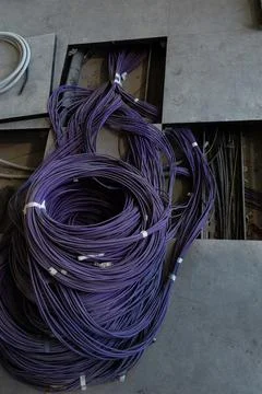 Installation of wiring and electrics under the floor of the office space Stock Photos