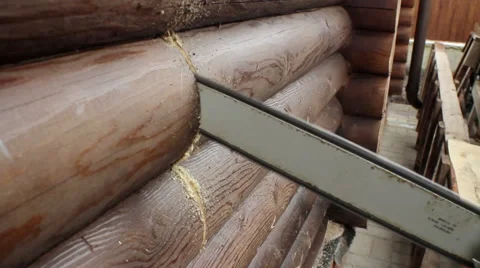 Installation of a wood stove. Worker making a hole in the felling with chainsaw. 库存影片 63625902