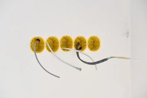 Installation of yellow wall sockets with cable Stock Photos