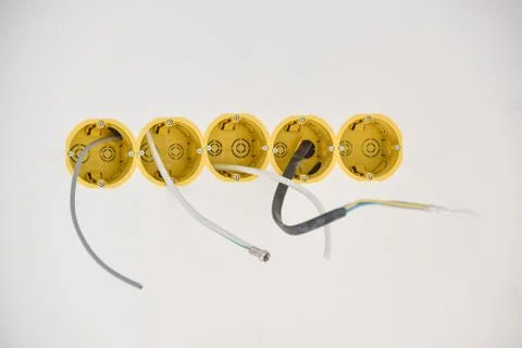Installation of yellow wall sockets with cable Stock Photos
