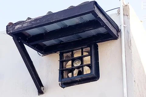 The installed window canopy protects the exhaust fan. Stock Photos