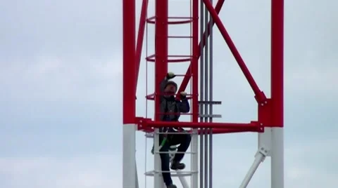 The installer climbs the tower up. Stock Footage 58030657