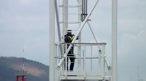 The installer climbs the tower up. Stock Footage 58030683