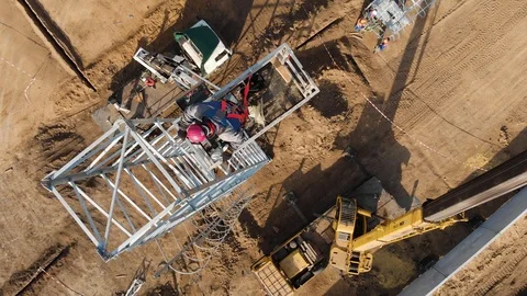An installer at a height in the hydraulic elevator basket instructs the crane Video stock 121199349