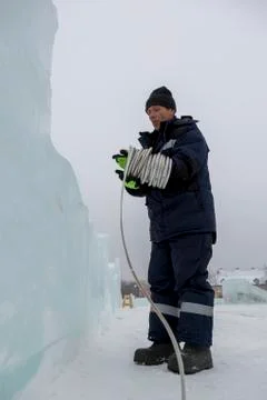 The installer is installing the power cable for lighting 写真素材