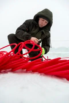 The installer is installing the power cable for lighting Stock Photos