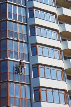 Installer worker finished the skyscraper facade Stock Photos