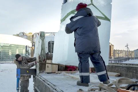Installers unloading ice blocks for an ice town 스톡 사진