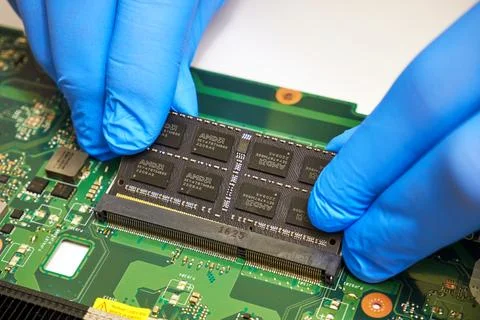 Installing an AMD RAM module on the motherboard close-up Stock Photos