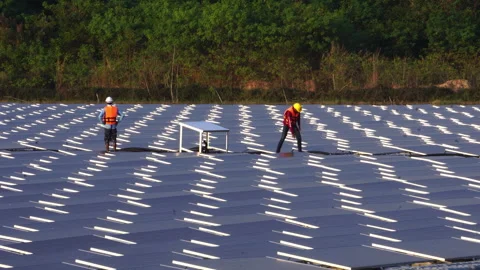 Installing and connecting solar panels on the like the surface of a pond water Stock Footage 248233582