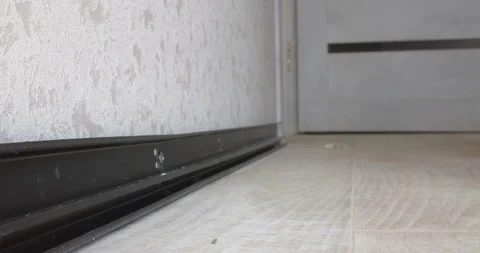 Installing the baseboard on the floor Stock Footage 306847073