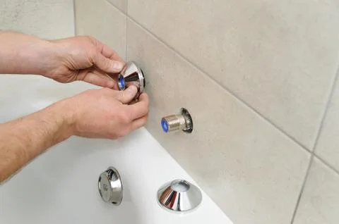 Installing bath faucet. Stock Photos