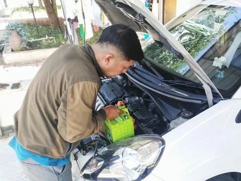 Installing battery in a car Stock Photos