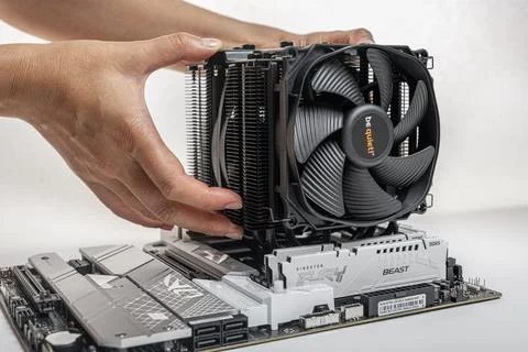 Installing a be quiet CPU cooler Dark Rock Pro 4 on the motherboard. Stock Photos