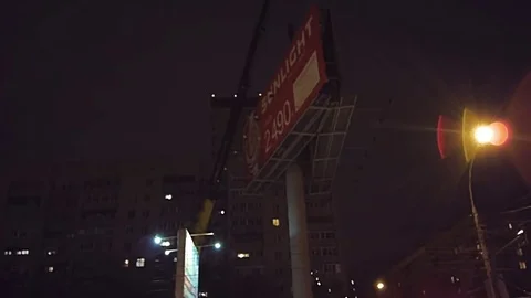 Installing the billboard at high altitude with a crane Stock Footage 78233581
