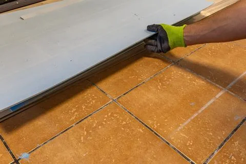 Installing Blue Foam Underlay for Vinyl or Laminate Flooring Home Renovation Stock Photos
