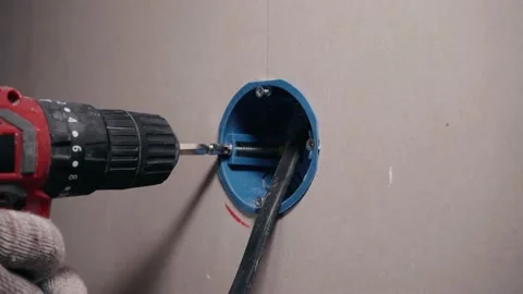 Installing a box for an electrical outlet in the wall Stock Footage 199045126
